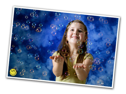 Immagine di una macchina Bolle di sapone con una bambina felice che gioca con le bolle di sapone.